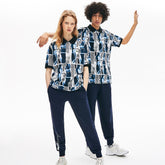 Mens Unisex LIVE Loose Fit Graphic Print Cotton Polo Shirt | Lacoste White / Blue / White • M3L